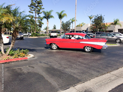 1957 chevy bel air classic car cruises in southern california with florida palm trees