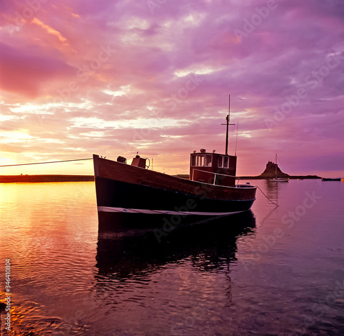 Colourful dawn at the small harbour at Lindisfarne Holy Island Northumberland