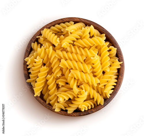 Fusilli pasta in wooden bowl isolated on white background, top view