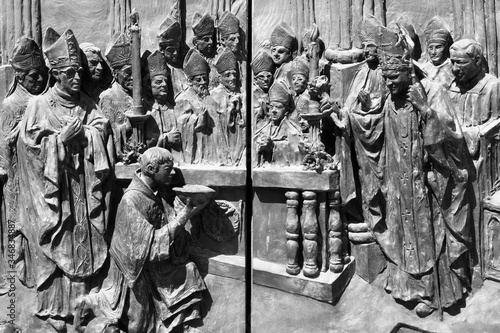 Bishops portrayed in Madrid Cathedral door. Black and white vintage style.
