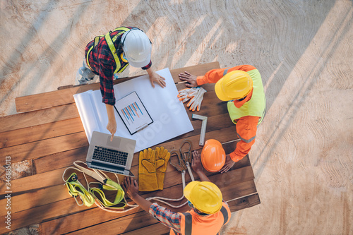 Team of engineer and architects working, meeting, discussing,designing, planning, measuring layout of building blueprints at construction site,Top view,Construction concept.