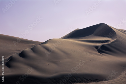 Sunset in the desert dunes, in the oasis of Huacachina Peru. One