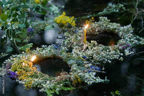 Ivan Kupala traditions - Wreath with candle on water