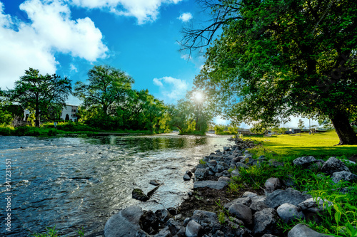 Sunset over a a flowing stream at a local park area in Burlington, Wisconsin USA.