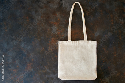 Blank cotton eco tote bag, design mockup. Eco-friendly bag on a black background.