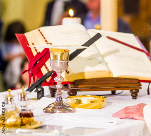 altar with missal and host which becomes the body of Christ and chalice to receive the wine, the blood of Christ