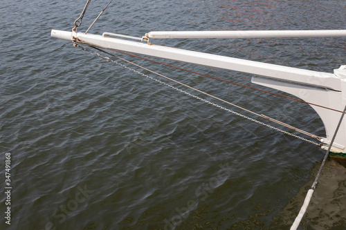 Bowsprit of a sailing vessel, calm sea water, creative copy space, horizontal aspect