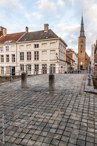 Buildings, street and church tower in Bruges