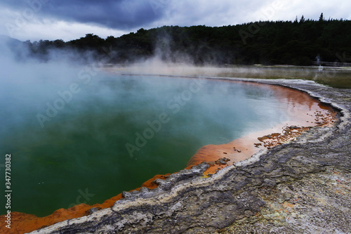Geothermal lake with an orange shoreline