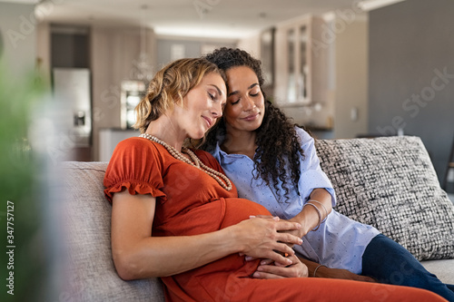 Lovely pregnant lesbian couple at home