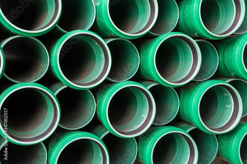 stack of green plastic pipes