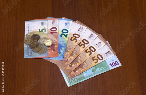 Euro banknotes and coins of different denominations on the table