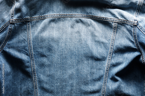 Back side of a vintage blue jeans or denim jacket with copy space