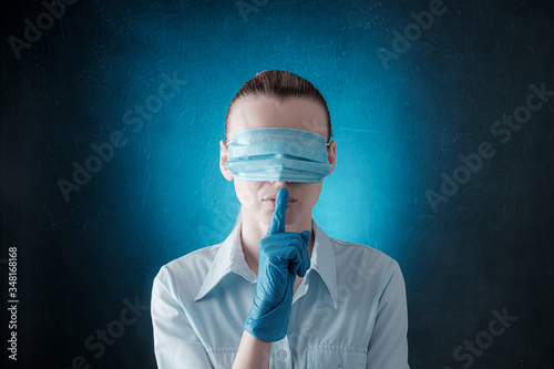 woman with medical face mask, dressed in eyes. concept of conspiracy, deception and misinformation about the state of affairs with the epidemic of coronavirus and quarantine