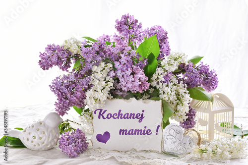 bunch of lilac blossoms for Mothers Day with inscription in Polish language translated as For dear mom