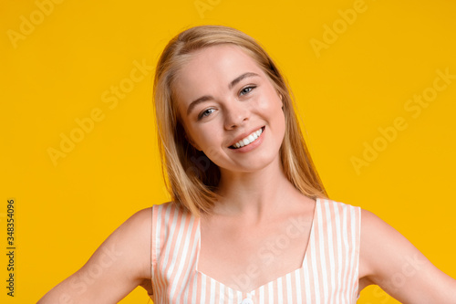 Charming Teen Girl Sincerely Smiling At Camera, Posing On Yellow Background