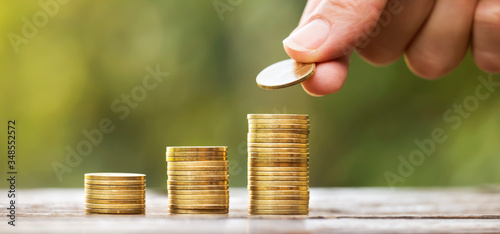 Growing gold money coins and hand, financial services concept, web banner with copy space