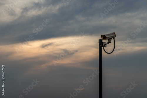 Modern surveillance camera on the sky background.