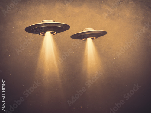 Two UFOs flying in fog with light below. 3D illustration monochromatic sepia-toned old-time photography. Concept image with blank space below the UFOs for texts and image.