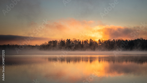 Sunrise on a foggy morning featuring a tree line at Lake Ontelaunee in Pennsylvania