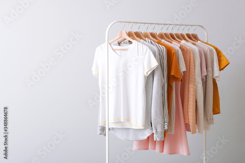 fashion clothes on a rack in a light background indoors. place for text