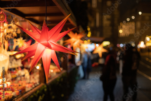 Christmas stars in a sale booth on a historic xmas market in Bremen, Germany with blurry Background and no people