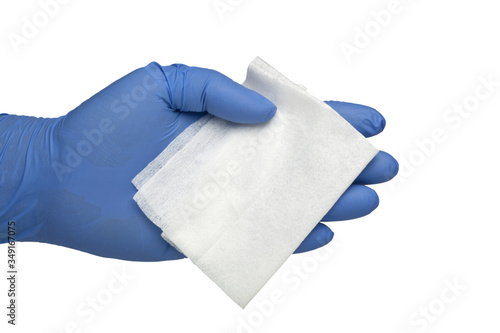 Gloved hand holding an antibacterial cleansing wipe