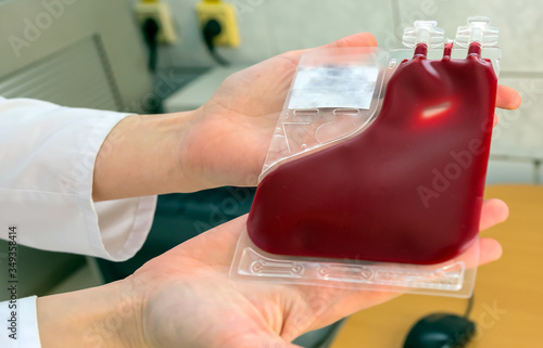 Placental cord blood bank donated blood unit prepared by gloved hands isolated.