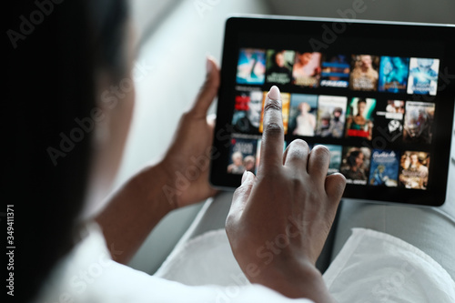 Black Woman Browsing Movie On Streaming Media Service