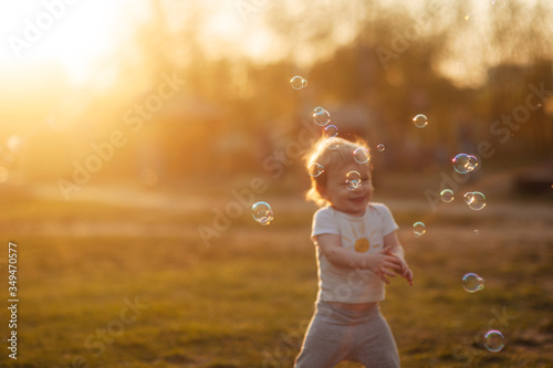 blurred background of a little boy in a clearing at golden hour