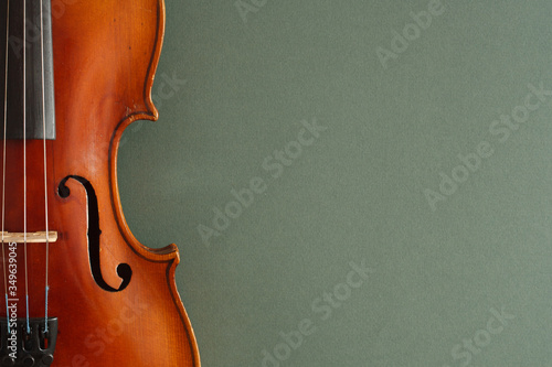 Classical music concert poster with brown color violin on dark green background with copy space for your text 