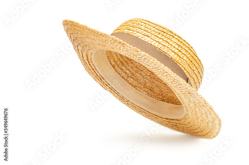 Boater straw hat flying isolated in studio. Concept of fashion clothing accessories and beach holidays