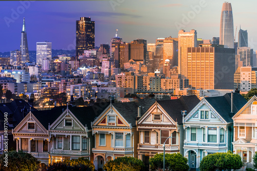 Traditional Victorian Houses known as Painted Ladies in Alamo Square and city skyline.