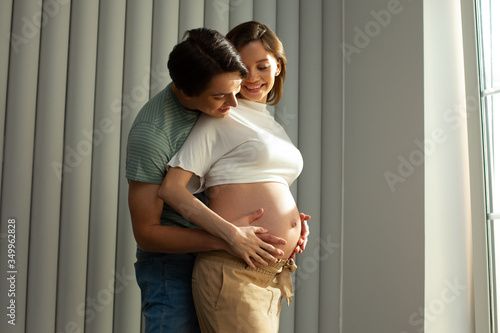 Happy young couple will become parents soon and feeling excited