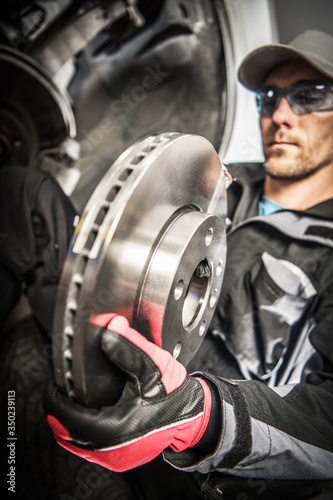 Car Mechanic Replacing Car Disc Brakes.