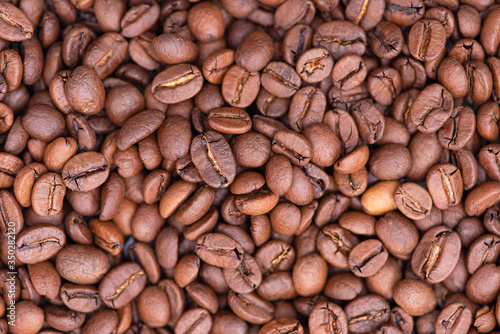 Roasted coffee beans as background, close-up, macro coffee bean, top view, high resolution