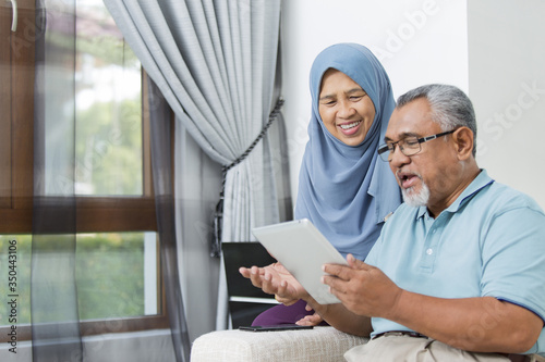 Senior couple using digital tablet