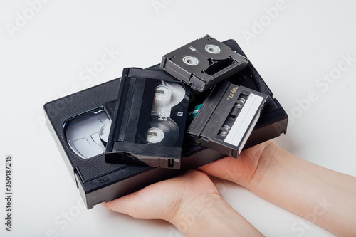 close up, video tape in child hand, isolated on white background, top view