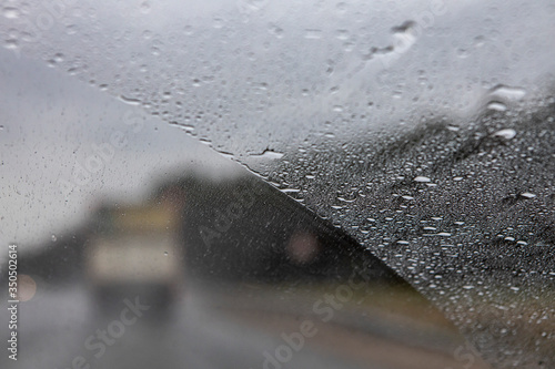the view from the window of a moving car in rainy weather. Defocused track and cars. Speed in poor visibility conditions