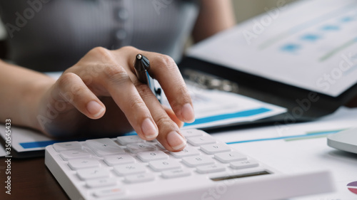 Close up accountant banker or bookkeeper making calculations with calculator. 