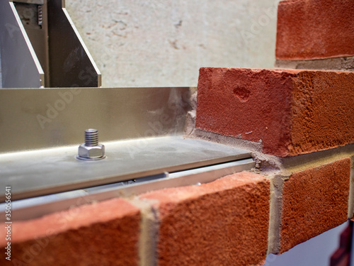 Steel reinforced brick wall construction