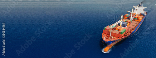 Aerial drone panoramic ultra wide photo of industrial container tanker ship cruising in open ocean deep blue sea 