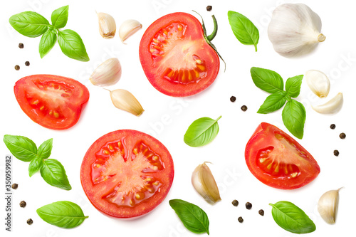 tomato slices with garlic and basil isolated on white background, top view