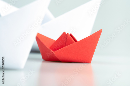 Small business, Business competition concept with red paper ship on white background