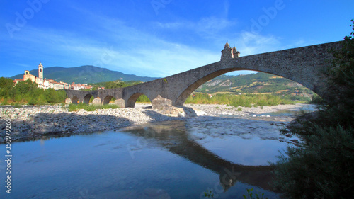 old bridge over the river in bobbio village in italy