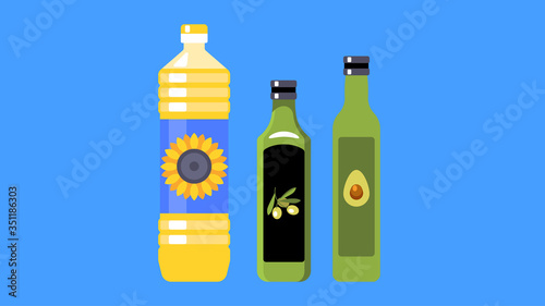 Three types of vegetable oil for cooking: sunflower, olive and avocado oil. Three different bottles.