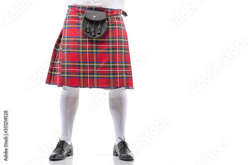 cropped view of Scottish man in red kilt with leather belt bag on white background
