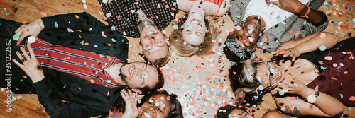 Group of friends lying on the floor at a party