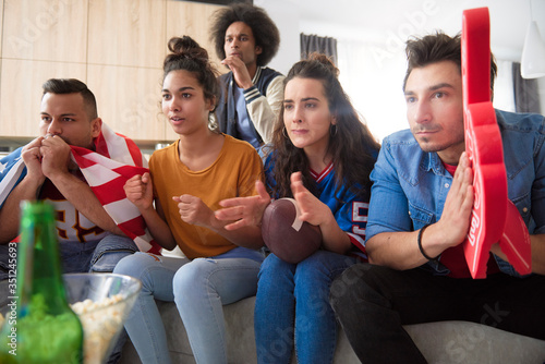 Friends waiting in suspense for the goal.