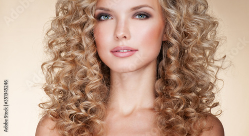 Beautiful blonde woman. Healthy Long Blond Hair. Curly Hair. Blond. Permed Hair. Afro curls. Long blond Hair. Beauty Model Girl with Luxurious Hair.